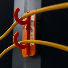 Load image into Gallery viewer, Tidi-Patch Magnetic fixed to a steel column to elevate temporary extension cords