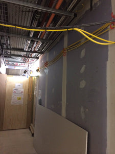 corridor kept safe from trip hazard by using tidi-hook to elevate cords